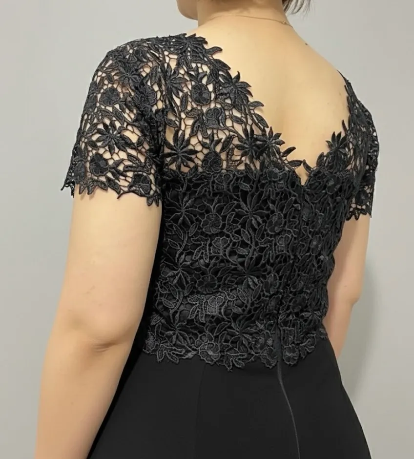 Back detail of a black guipure lace top with scalloped V neckline