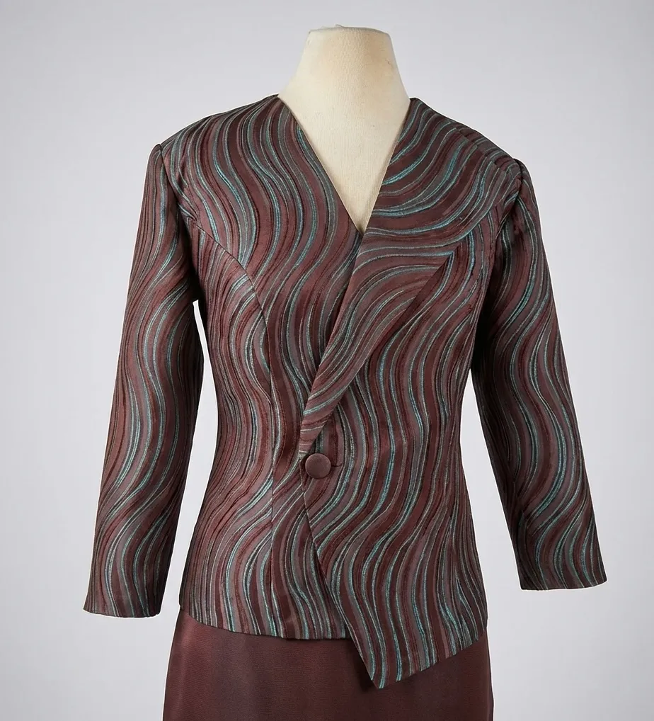 Wrap jacket in wavy striped brocade with single button closure