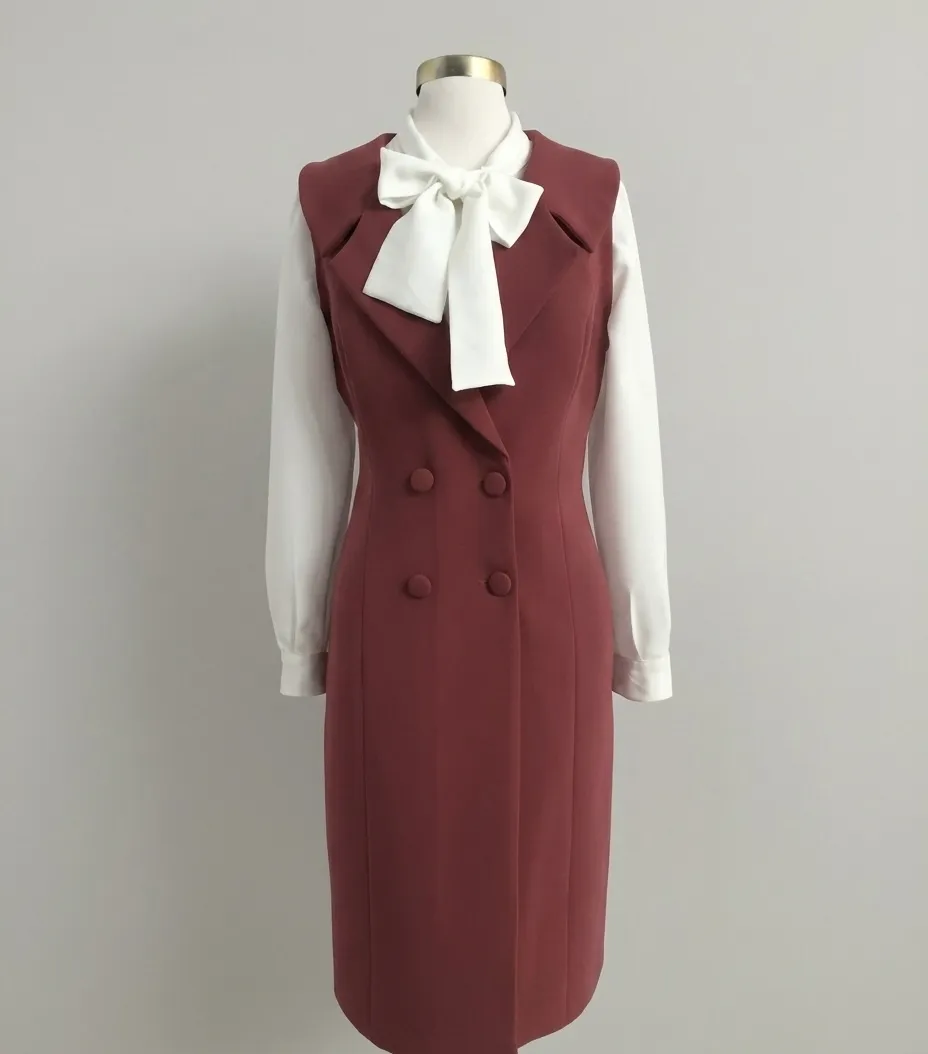 Burgundy double-breasted pinafore dress over a white bow blouse
