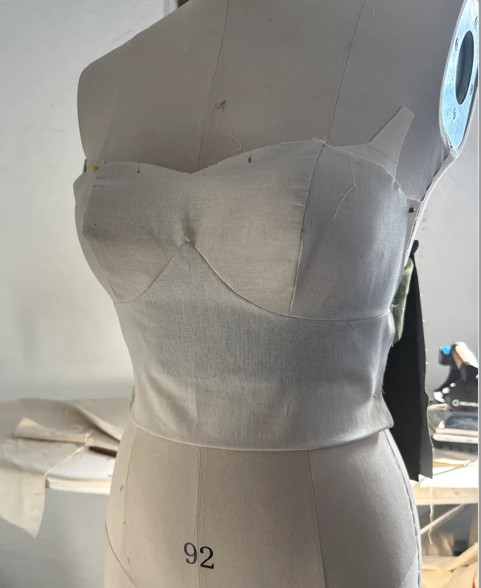 Bustier bodice being fitted and adjusted on a dress form